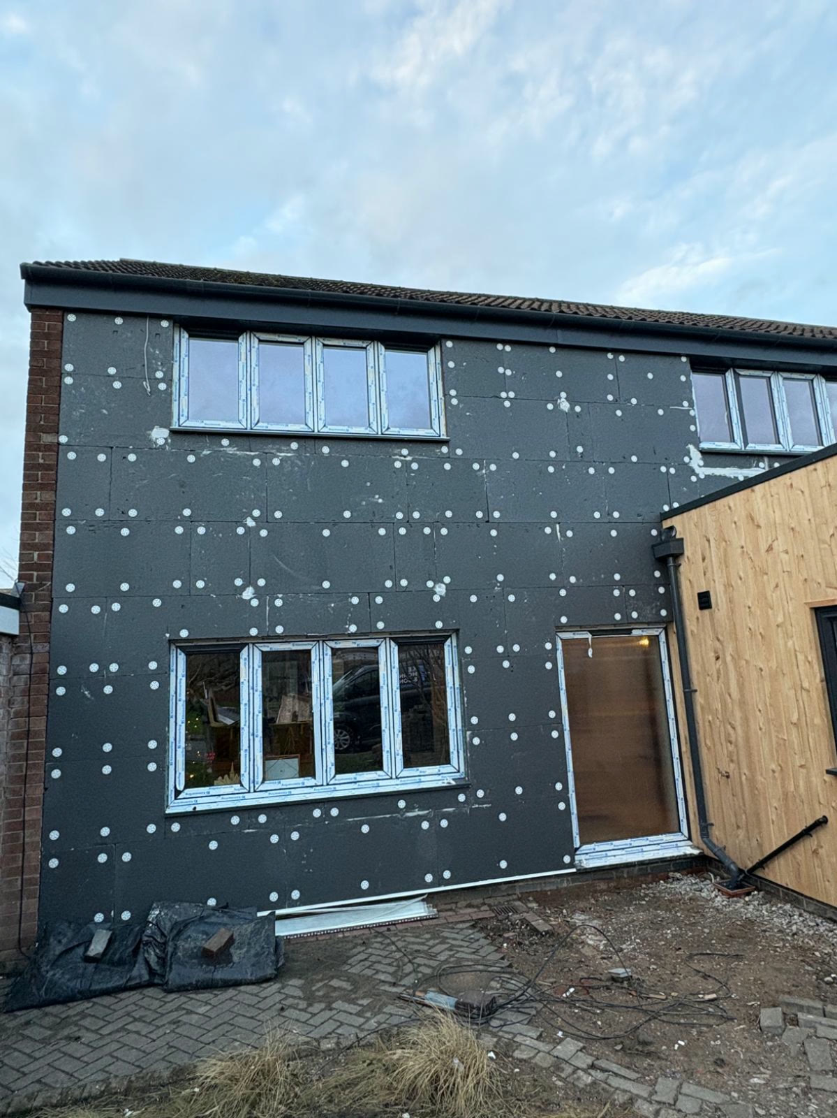 Insulation boards mechanically fixed to a front elevation, ready for basecoat and render