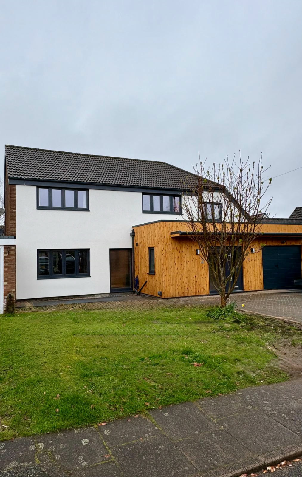 A detached house finished in white silicone render
