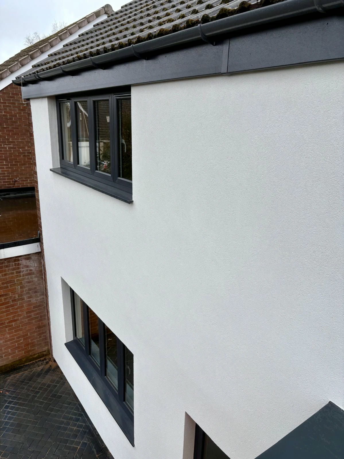 Close-up of a finished silicone render elevation showing an even, consistent texture