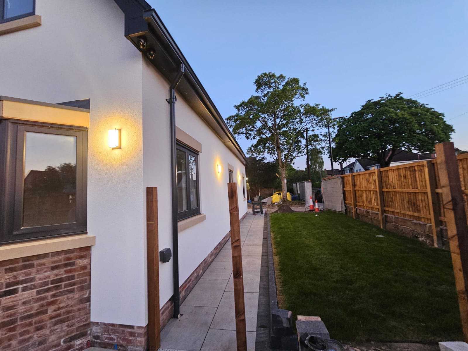The rendered side elevation at dusk with external lighting